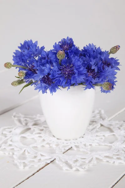 Blue cornflowers in vase — Stock Photo, Image