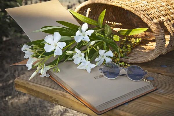 White flowers with basket and sunglasses — Stock Photo, Image
