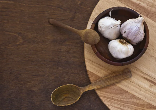 Garlic with wooden spoon — Stock Photo, Image