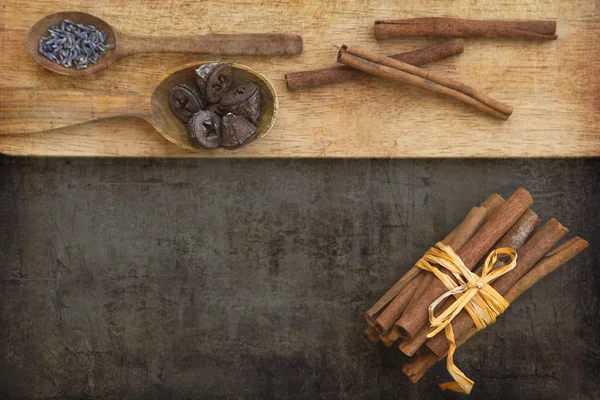 Wooden spoons with spices and cinnamon sticks — Stock Photo, Image