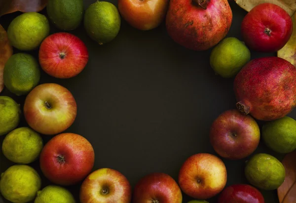 Red apples, pomegranate and limes — Stock Photo, Image