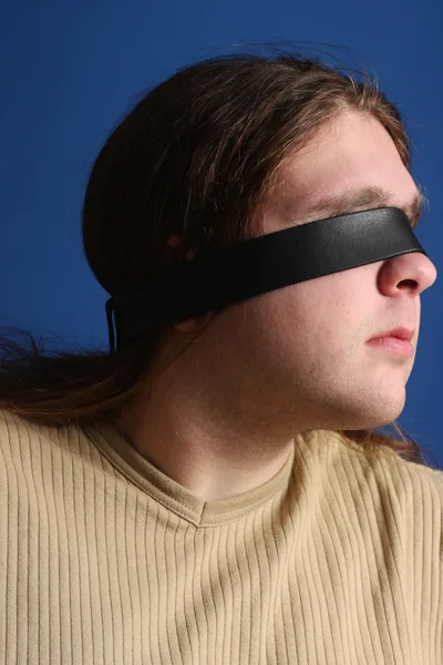 Man with a belt over his eyes — Stock Photo, Image