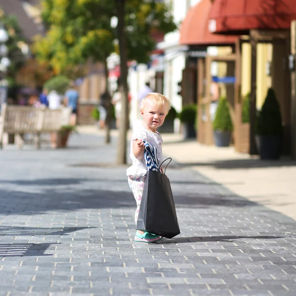 Girl with black shopping bag in her hands, — Stock Photo, Image