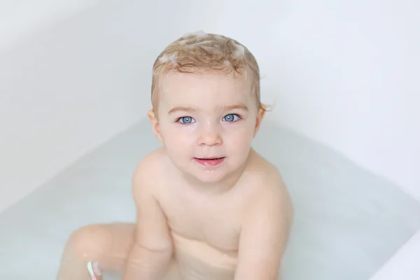 Adorable little baby girl sitting in a bath — Stock Photo, Image