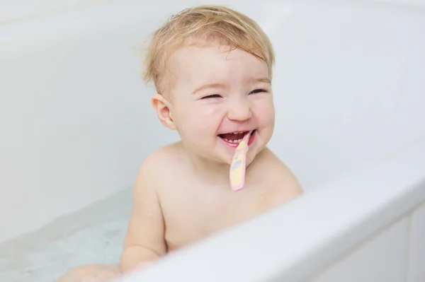 Chica cepillarse los dientes sentado en el baño —  Fotos de Stock