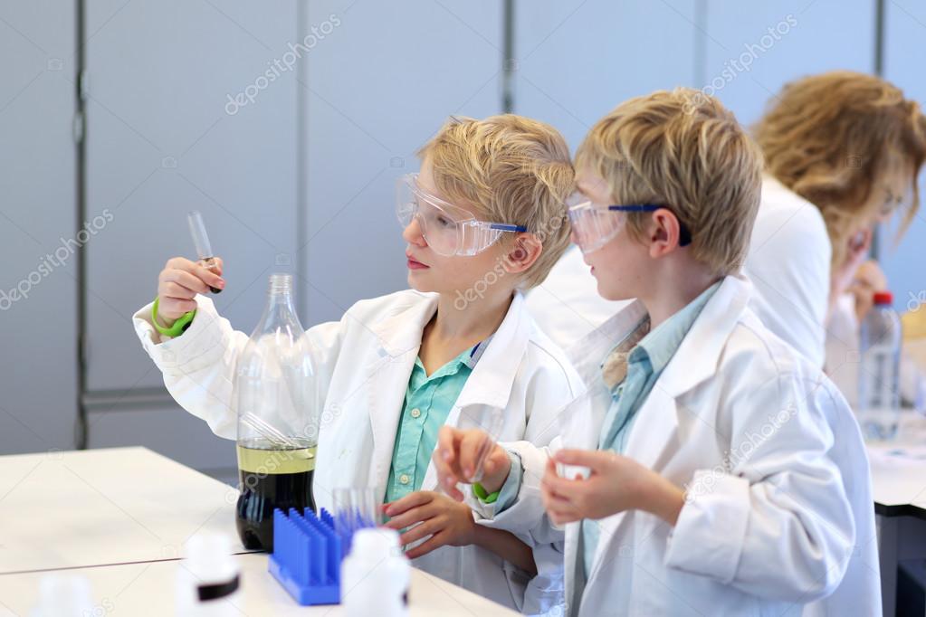 School boys making experiments in the chemical laboratory