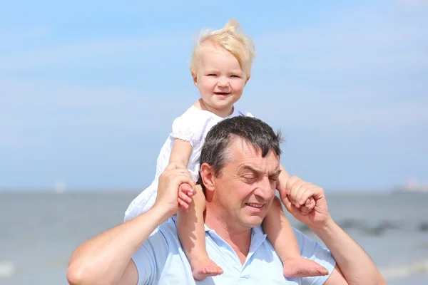 Baby girl sitting on shoulders of her father — Stock Photo, Image