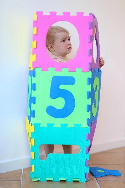 Girl learning numbers with colorful soft puzzles — Stock Photo, Image