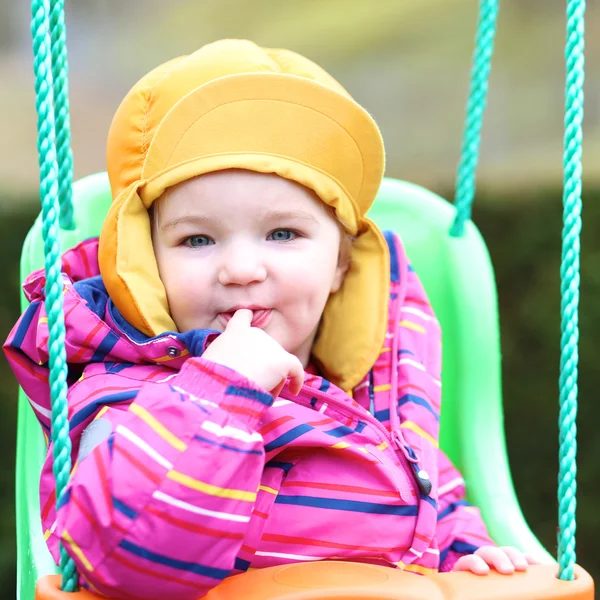 Girl rocking outdoors on the swing — Stock Photo, Image