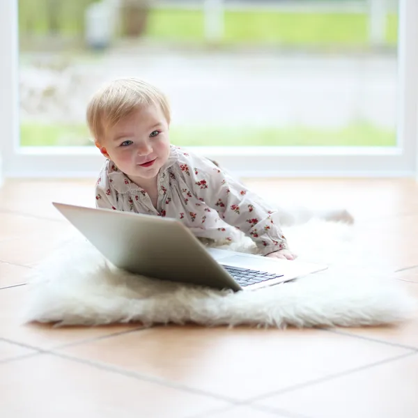Girl playing with notebook — Stock Photo, Image