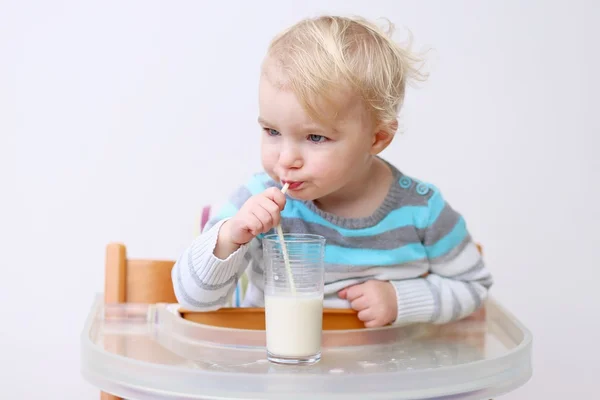 Meisje drinken melk uit het glas met stro — Stockfoto