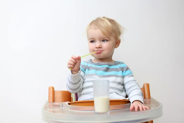 Girl drinking milk from the glass with straw — Stock Photo, Image