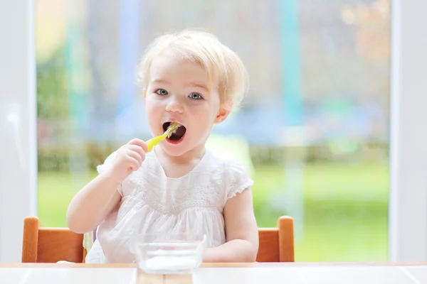 Menina comendo iogurte delicioso — Fotografia de Stock