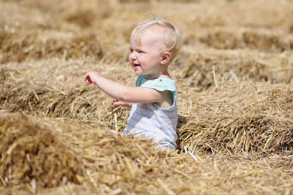 Baby girl playing with straw — Stock Photo, Image