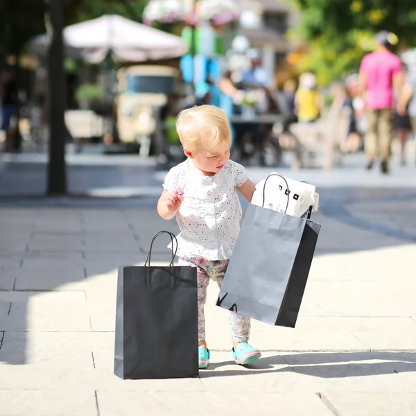 Girl with black shopping bags in her hands — Stock Photo, Image