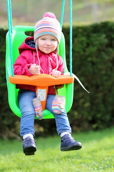 Girl playing outdoors on the swing — Stock Photo, Image