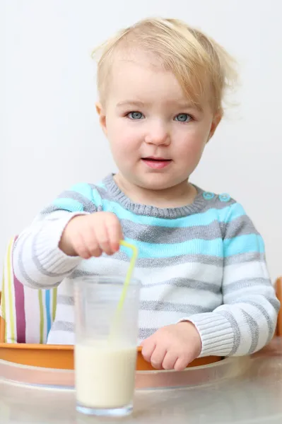 Meisje drinken melk uit het glas met stro — Stockfoto