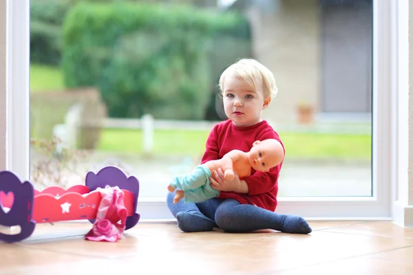 Girl playing with doll — Stock Photo, Image