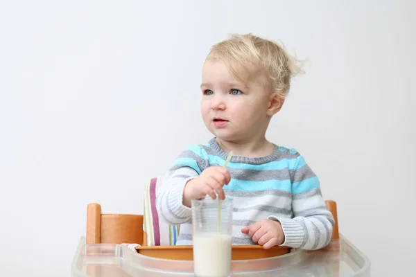 Girl drinking milk from the glass with straw — Stock Photo, Image