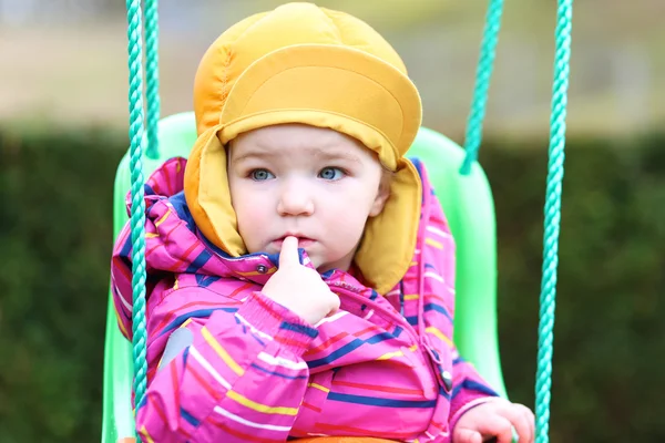 Girl rocking outdoors on the swing — Stock Photo, Image