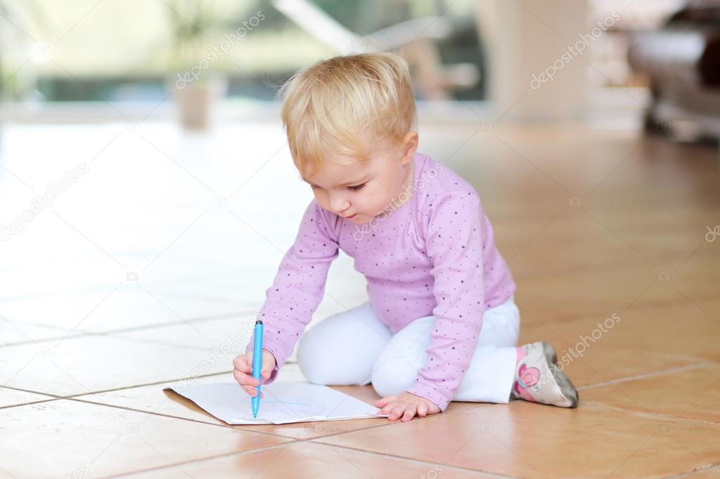 Baby girl drawing with colorful pencils