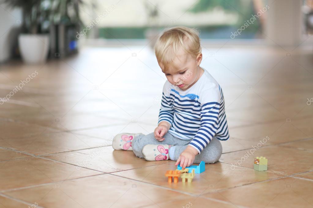 Baby girl play with plastic bricks