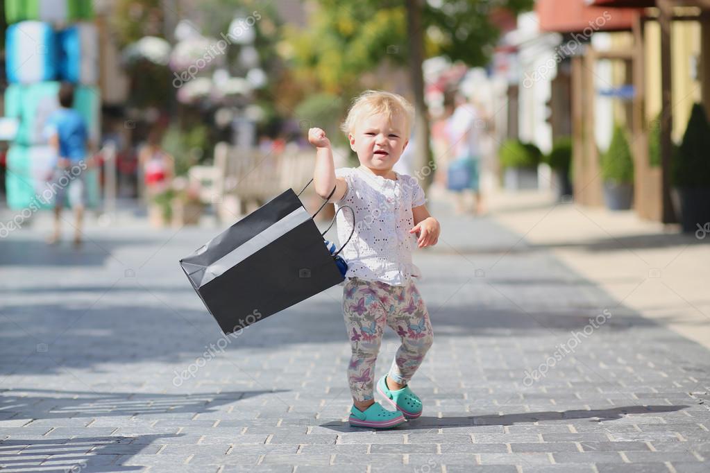 Cute Baby Girl Standing Or Walking In The Middle Of The Street In