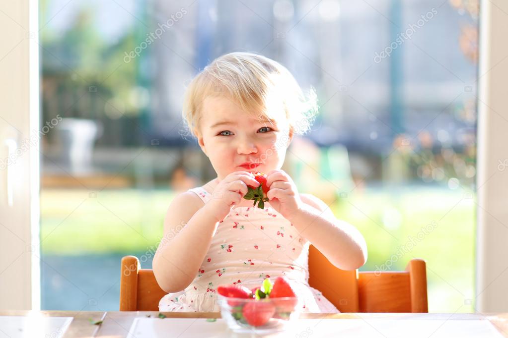Girl eating strawberries