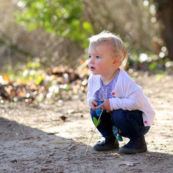 Girl with blonde curly hair playing in the forest — Stock Photo, Image