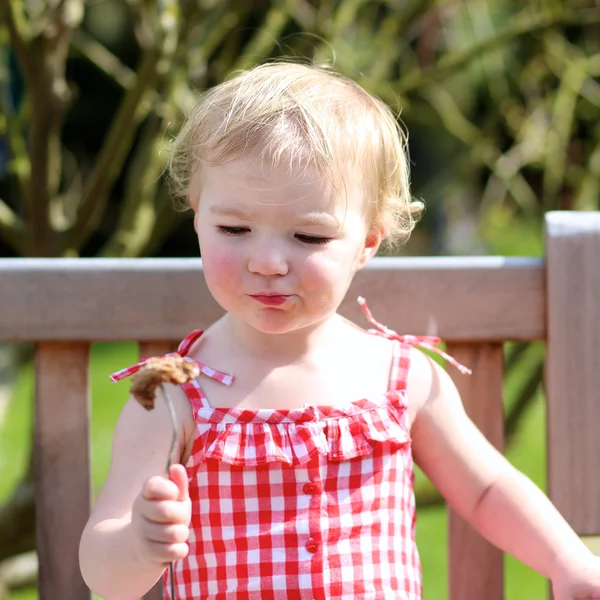 Girl eating  meat made on barbeque — Stock Photo, Image