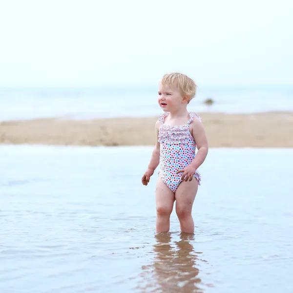 Ευχαρίστως toddler κορίτσι, παίζοντας στην παραλία — Φωτογραφία Αρχείου