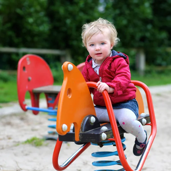 Child riding on the spring horse — Stock Photo, Image