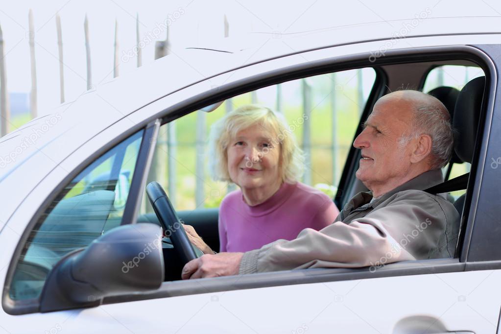 Senior couple driving car