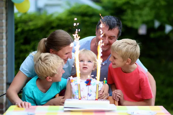Happy family of five celebrating birthday of 2 years old child with cake and candles — Stock Photo, Image