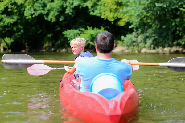 Vater und Sohn paddeln auf dem Fluss — Stockfoto