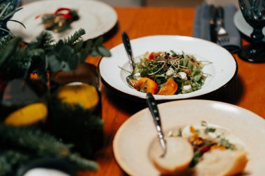 Caesar salad in a beautiful plate on a served table restaurant is decorated with microgreens