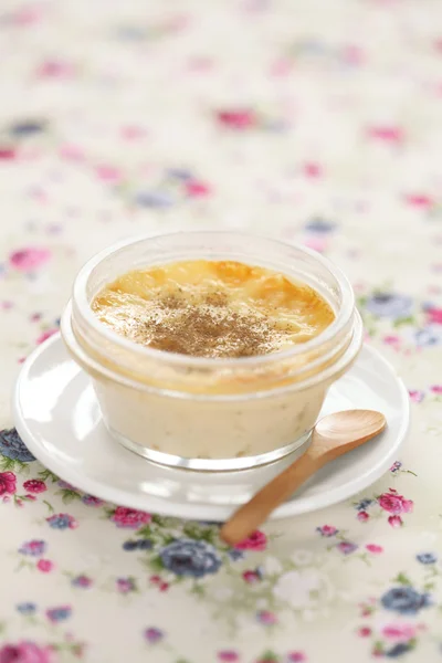 Creme Brulee in transparent pot, on light background — Stock Photo, Image