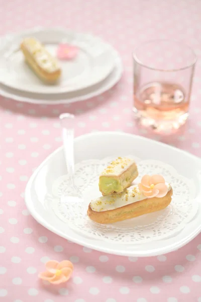Pistachio Eclairs on a white plate — Stock Photo, Image