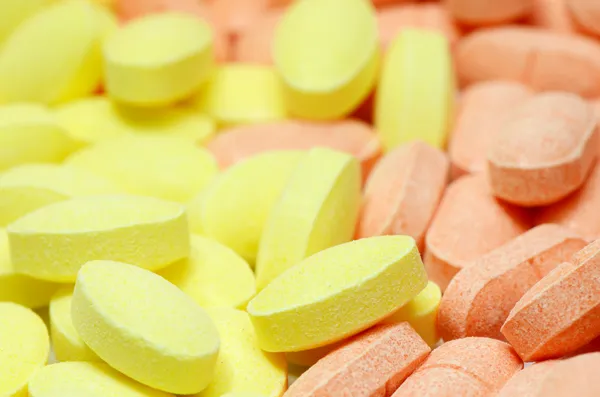 Varios colores de las píldoras de vitamina C (ácido ascórbico) en el mercado. Las tabletas de vitamina C ahora se utilizan en el concepto antioxidante más que prevenir la clod común o el escorbuto . —  Fotos de Stock