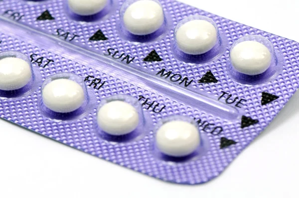 Comprimido contraceptivo com instruções em inglês fechado-up sobre fundo branco . — Fotografia de Stock