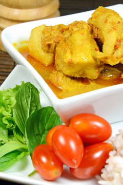 Spicy Pork Rib Curry with Tumeric Root Served with Fresh Vegetable, Tomatoes and Streamed Rice.