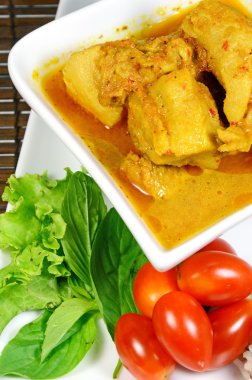 Spicy Pork Rib Curry with Tumeric Root Served with Fresh Vegetable, Tomatoes and Streamed Rice.
