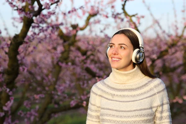 Kışın Mutlu Bir Kadın Kulaklık Takıyor Tarlada Müzik Dinliyor — Stok fotoğraf