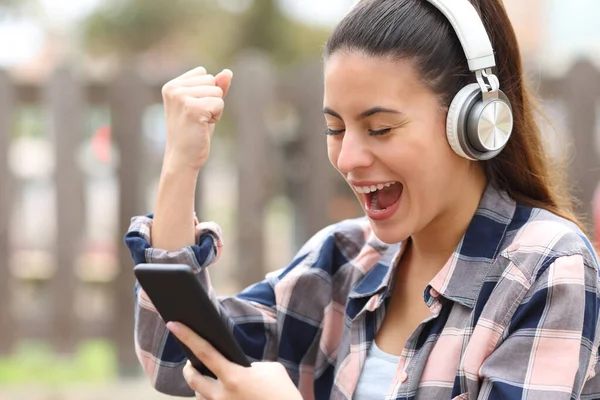 Excited Teen Wireless Headphones Checking Smart Phone Park — Foto de Stock