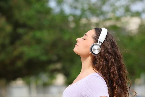 Side View Portrait Relaxed Woman Wearing Headphones Listening Audiobook Meditating — стоковое фото