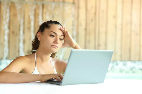 Worried Woman Unable Relax Using Laptop Spa — Stock fotografie