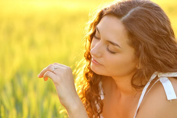 Relaxed Engaged Woman Looking Ring Field Sunset Beautiful Warm Light — стоковое фото