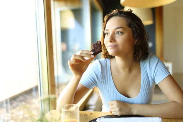 Woman Holding Eating Chocolate Cupcake Sitting Restaurant Looking Window — Foto de Stock