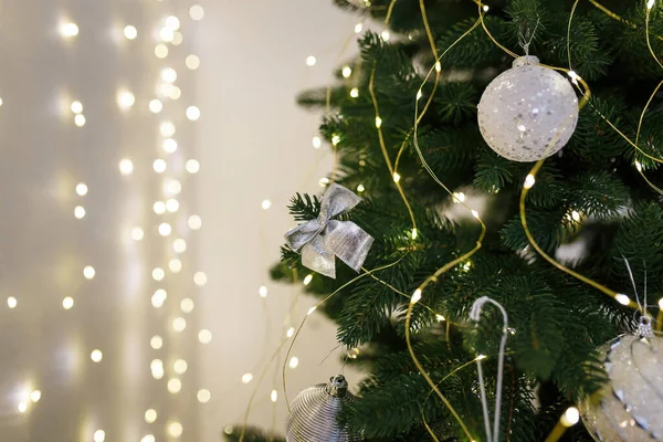 Silver Bauble Bow Fir Tree Branch Garland Lights Bokeh Background — Stock Photo, Image