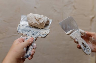 Duvarda macun kullanan spatula kullanan erkek eller, tadilat yapan inşaatçılar..
